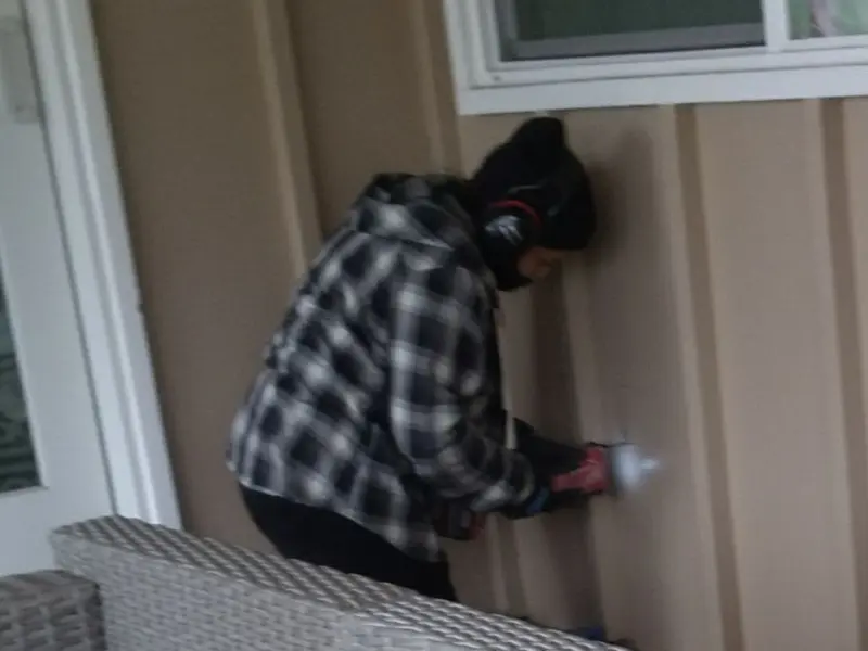 Professional electrician installing an exterior outlet in Newport