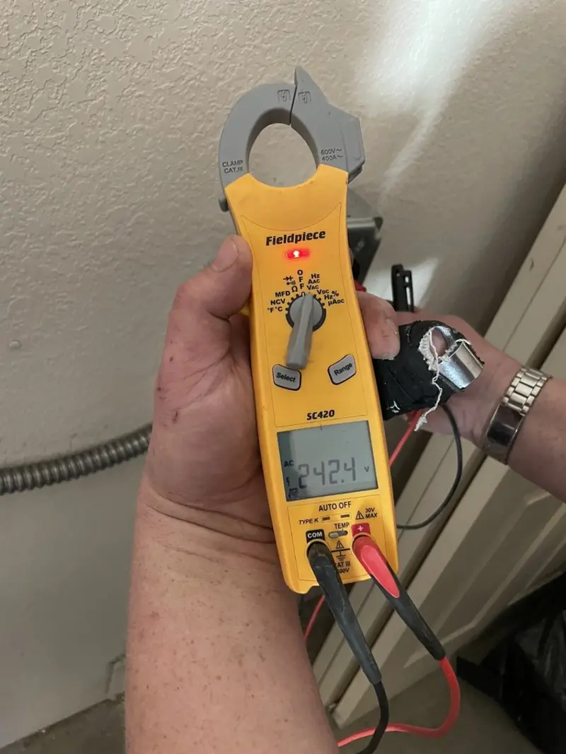 Voltage testing with clamp meter during Electrical Installation Services in Newport